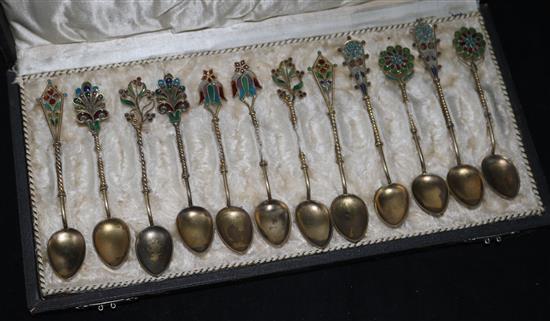 Twelve cased plique a jour enamel coffee spoons.